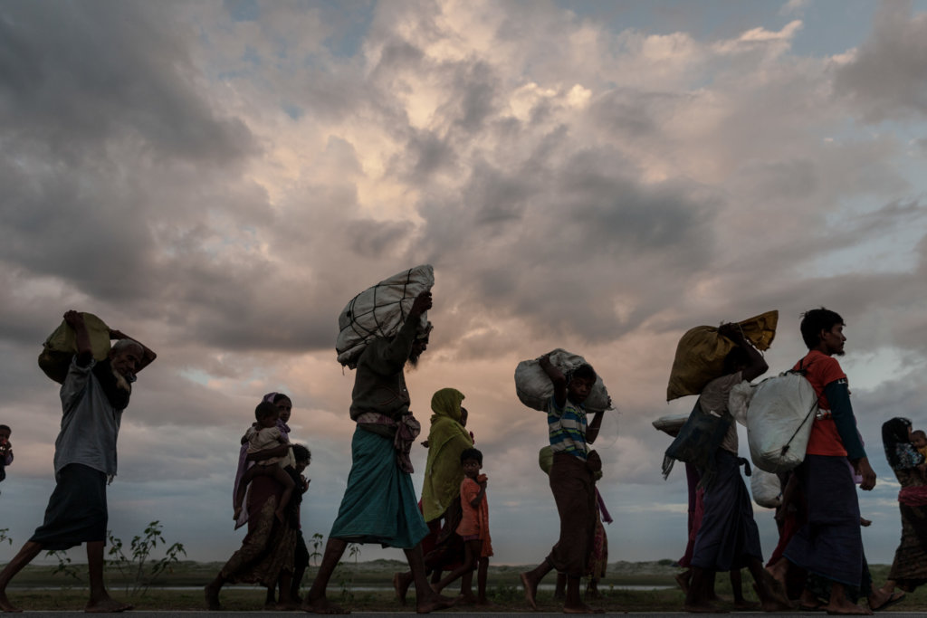 Newly arrived Rohingya refugees walk to the nearest refugee reception point in the coastal village of Shamlapur in Cox's Bazar District, Bangladesh. Myanmar Army-led attacks forced more than 700,000 Rohingya to flee to Bangladesh beginning in August 2017. Patrick Brown © Panos/UNICEF 2018