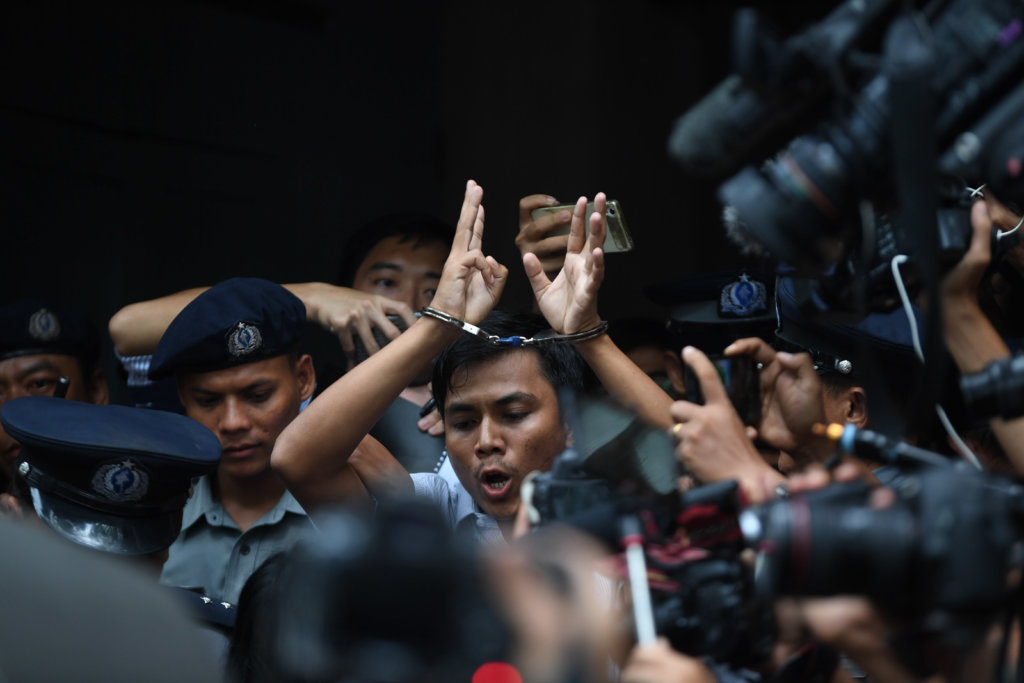 Kyaw Soe Oo escorted by police officers out of Yangon court. ©Mar Naw, 2018