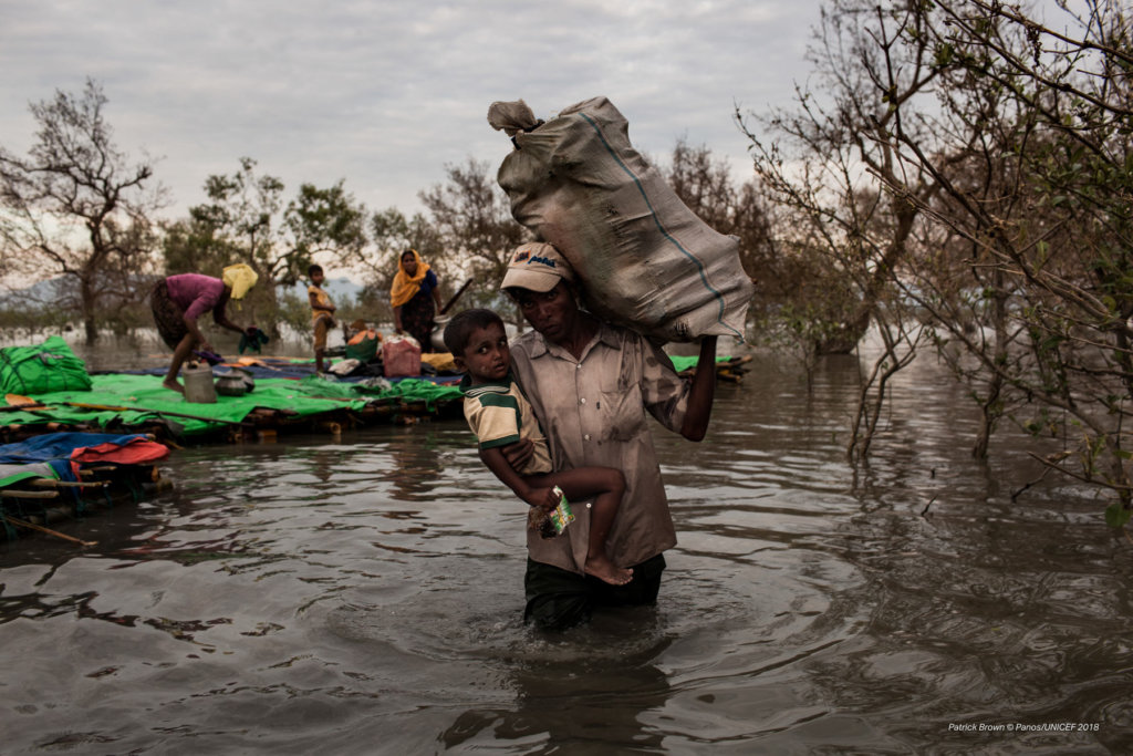 Stranded on the Myanmar border for up to three weeks, Rohingya refugees cross the Naf River into Bangladesh—a five to seven-hour-long journey—on makeshift rafts made of bamboo, tarp, and empty palm-oil cans. Patrick Brown © Panos/ UNICEF 2018